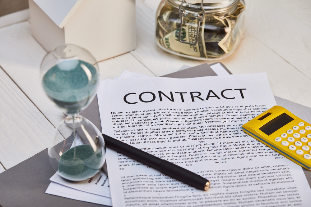 Contract, calculator, and hourglass for reviewing estimates from pool enclosure companies